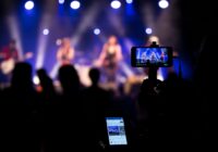 people taking videos during concert