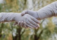 person holding babys hand
